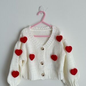 White Cardigan with Red Heart Accents